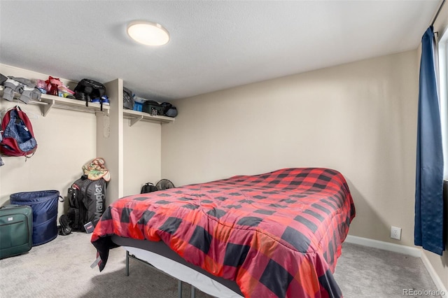 carpeted bedroom featuring baseboards