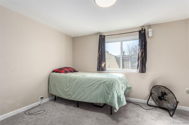 bedroom featuring carpet and baseboards