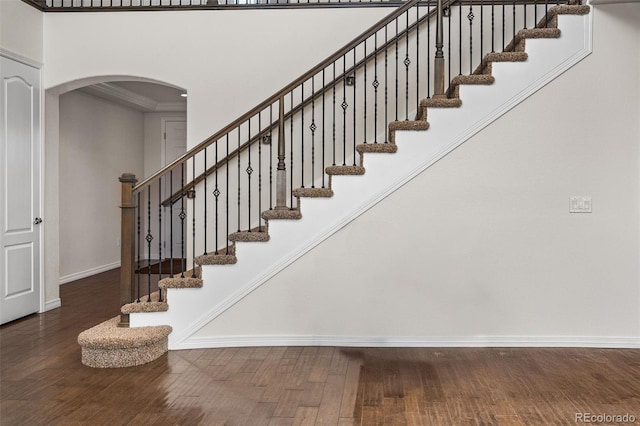 staircase with hardwood / wood-style floors