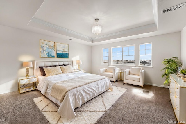 bedroom featuring a raised ceiling, ornamental molding, carpet flooring, and a chandelier