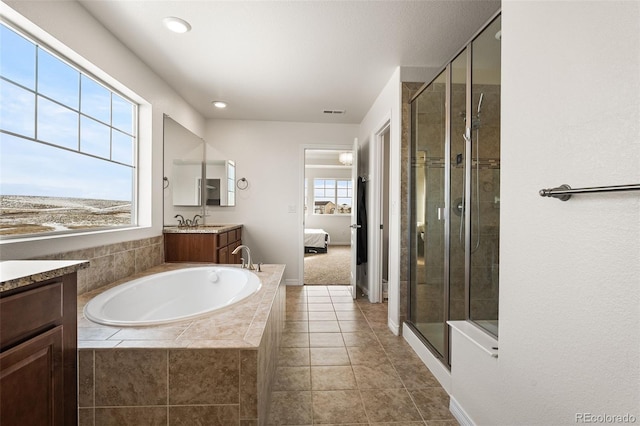 bathroom with tile patterned flooring, vanity, and separate shower and tub