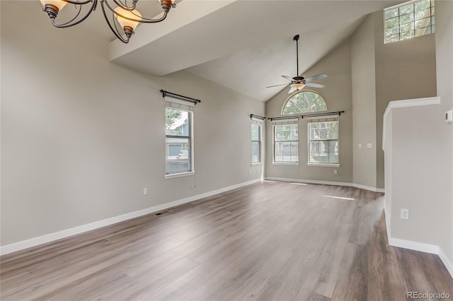 6735 W 97th Cir, Westminster, CO 80021 - unfurnished room with a chandelier, wood finished floors, ceiling fan, baseboards, and high vaulted ceiling