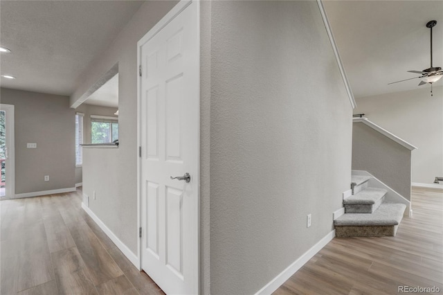 6735 W 97th Cir, Westminster, CO 80021 - hallway with wood finished floors, baseboards, stairs, a textured wall, and recessed lighting