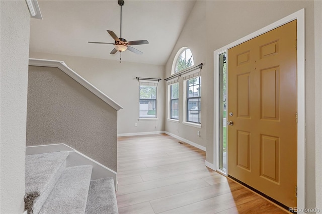 6735 W 97th Cir, Westminster, CO 80021 - entryway featuring wood finished floors, stairs, a textured wall, ceiling fan, and high vaulted ceiling