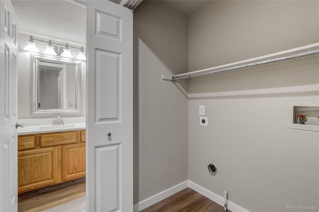 6735 W 97th Cir, Westminster, CO 80021 - laundry area with hookup for an electric dryer, wood finished floors, washer hookup, and baseboards