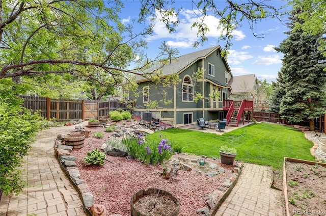 6735 W 97th Cir, Westminster, CO 80021 - rear view of property featuring a patio area, stairs, a wooden deck, central AC, and a shingled roof