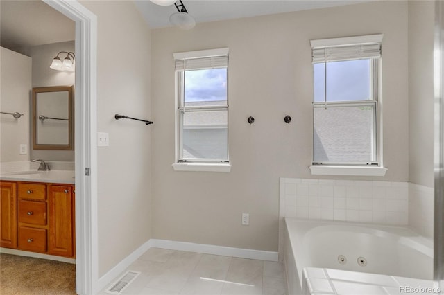 6735 W 97th Cir, Westminster, CO 80021 - full bath featuring healthy amount of natural light, a whirlpool tub, baseboards, and vanity