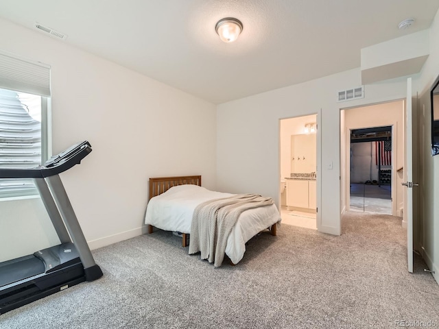 carpeted bedroom featuring connected bathroom