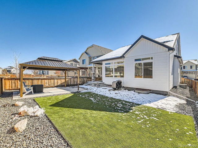 back of house with a gazebo, a patio area, and a lawn