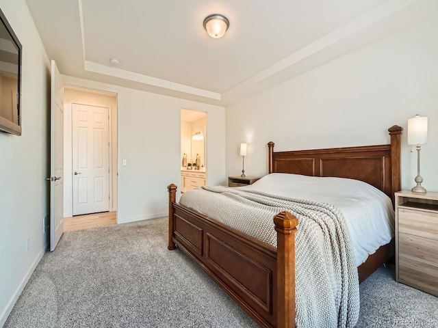 carpeted bedroom featuring ensuite bath