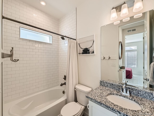 full bathroom featuring vanity, shower / tub combo, and toilet