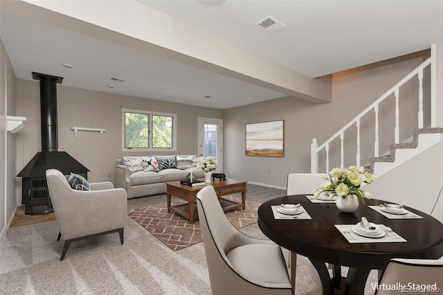 living room with a wood stove and carpet