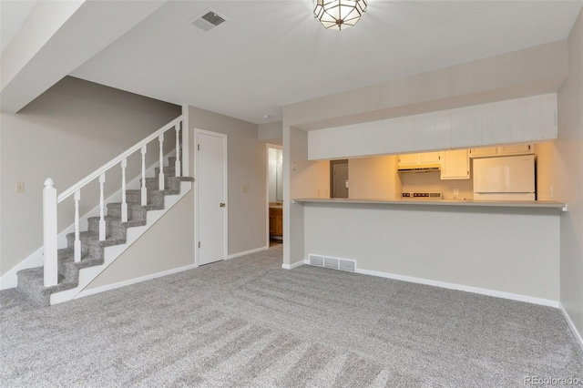 unfurnished living room featuring carpet flooring