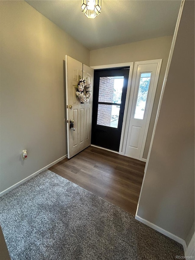 entryway featuring wood finished floors and baseboards