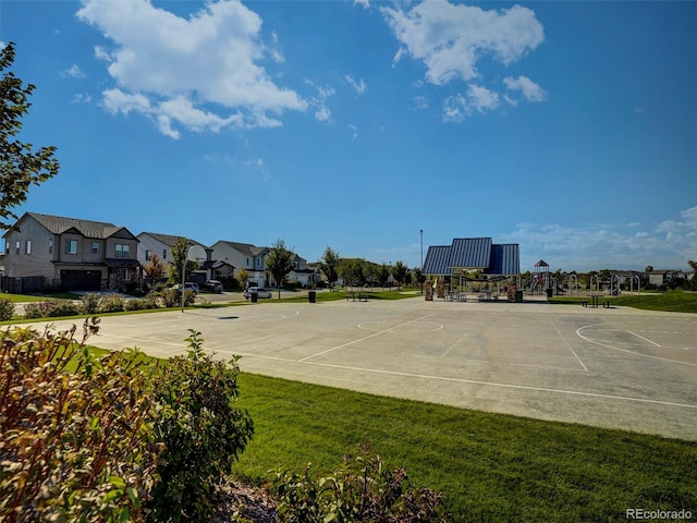 view of basketball court with a lawn