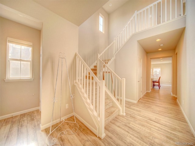 stairway featuring hardwood / wood-style floors and a healthy amount of sunlight