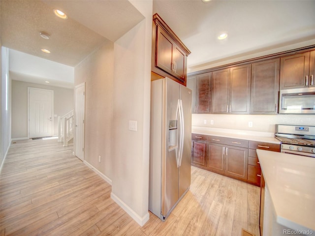 kitchen with light hardwood / wood-style floors and stainless steel appliances