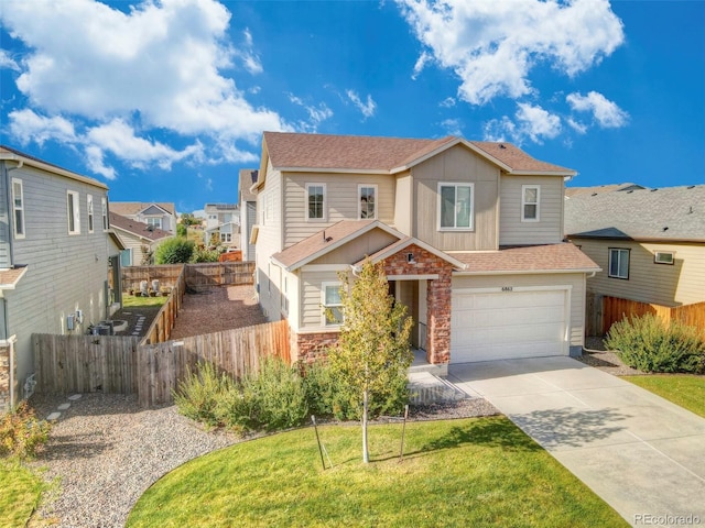 view of front of property featuring a garage and a front lawn