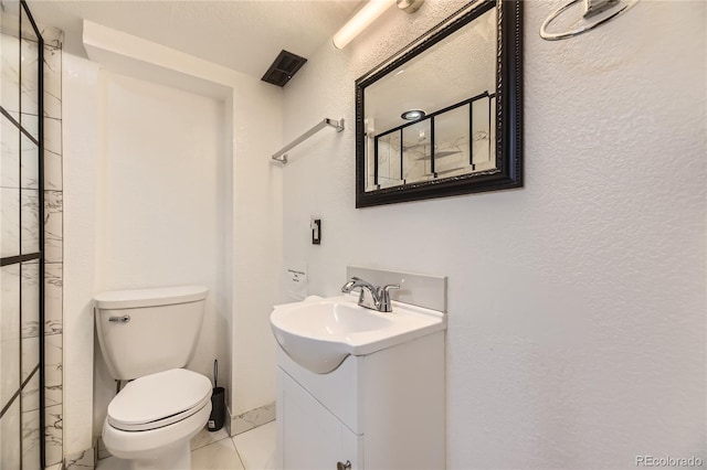 10633 E 6th Pl, Aurora, CO 80010 - full bathroom featuring vanity, marble finish floors, toilet, and a textured wall