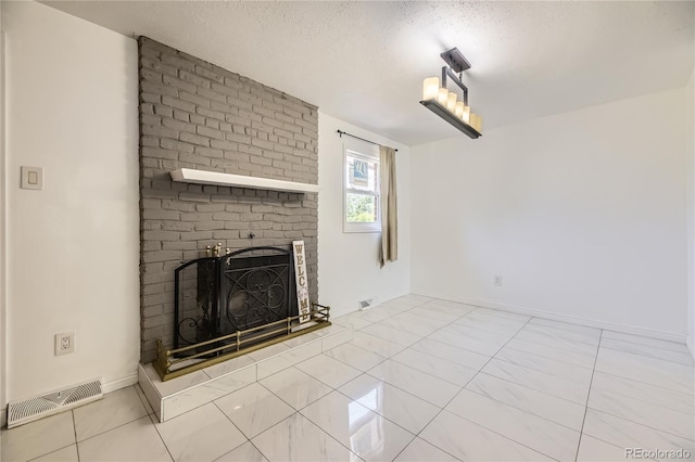 10633 E 6th Pl, Aurora, CO 80010 - unfurnished living room featuring a brick fireplace, a textured ceiling, and baseboards