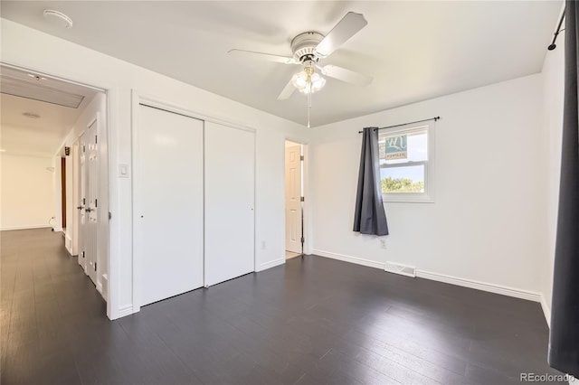 10633 E 6th Pl, Aurora, CO 80010 - unfurnished bedroom featuring dark wood-type flooring, a closet, baseboards, and a ceiling fan
