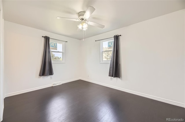 10633 E 6th Pl, Aurora, CO 80010 - empty room featuring plenty of natural light, baseboards, dark wood-style flooring, and a ceiling fan