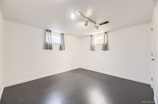 10633 E 6th Pl, Aurora, CO 80010 - below grade area featuring baseboards, dark wood finished floors, and rail lighting