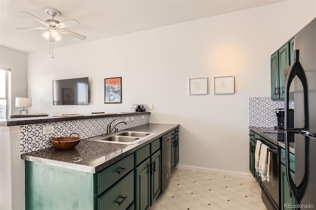 kitchen featuring a peninsula, green cabinetry, a sink, and tasteful backsplash