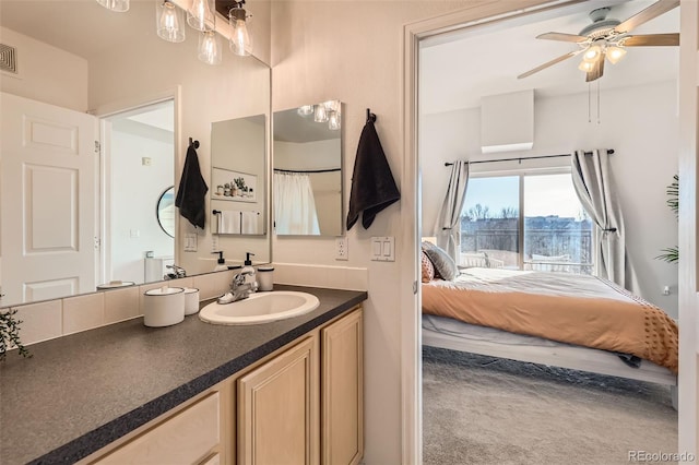 bathroom with vanity, connected bathroom, ceiling fan, and visible vents