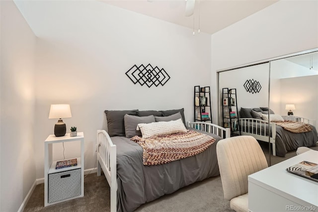 carpeted bedroom with baseboards and a closet