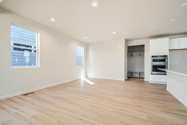 unfurnished living room featuring light wood-type flooring