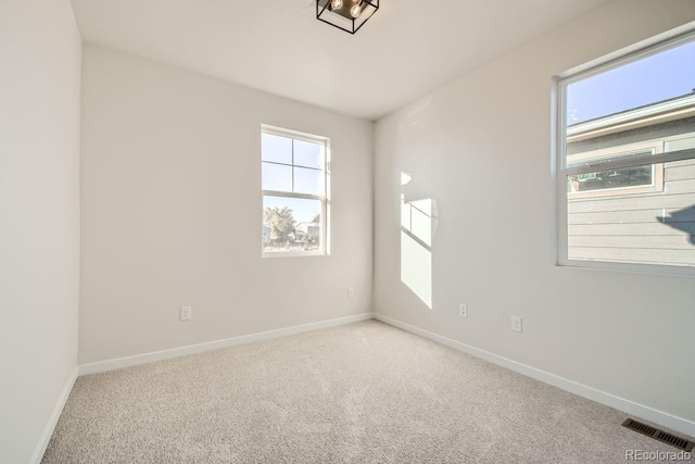 unfurnished room with light carpet