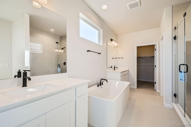 bathroom featuring tile patterned floors, vanity, and plus walk in shower