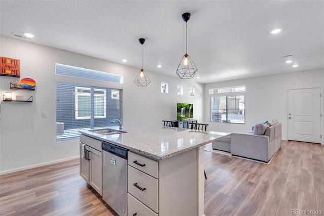 kitchen with white cabinets, sink, decorative light fixtures, dishwasher, and an island with sink