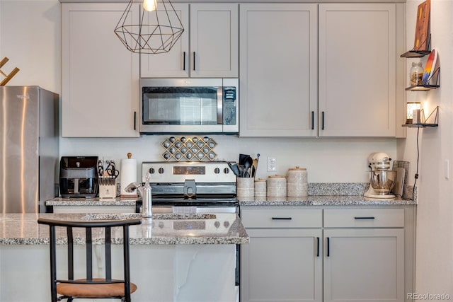 kitchen featuring light stone counters and stainless steel appliances