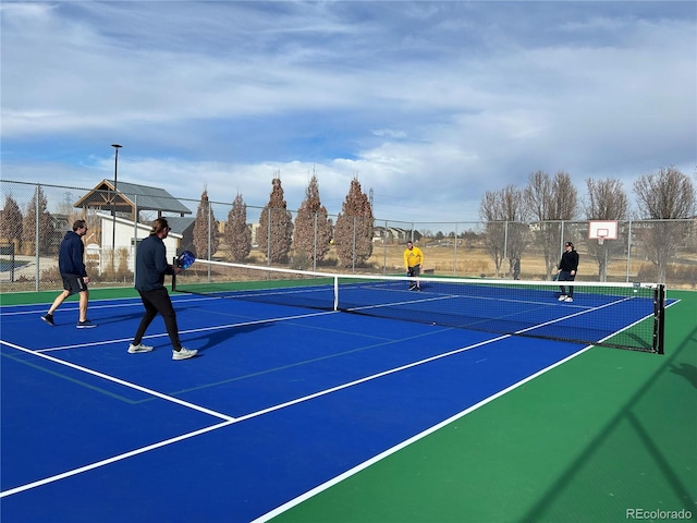 view of tennis court with basketball hoop