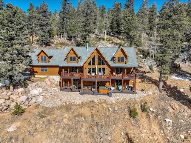 back of property featuring a deck and a patio area