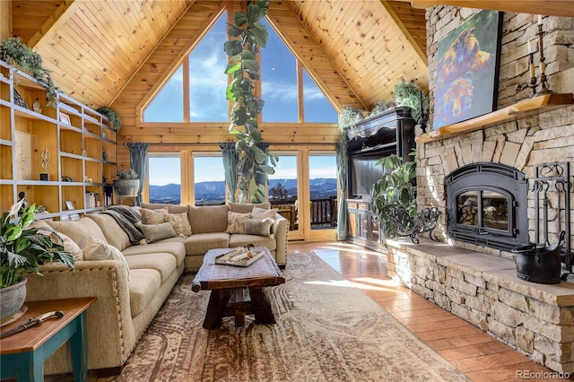 living room with hardwood / wood-style flooring, beam ceiling, wood ceiling, wood walls, and high vaulted ceiling