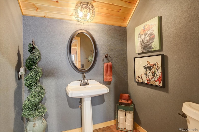 bathroom with wood ceiling and toilet