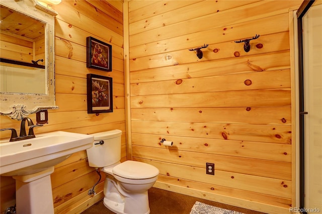 bathroom with wooden walls and toilet