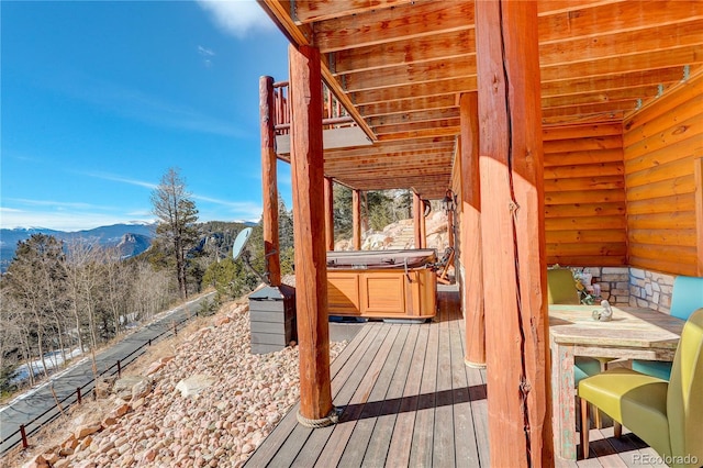 wooden terrace featuring a hot tub and a mountain view