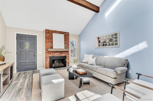 7707 S Curtice Way Unit D, Littleton, CO 80120 - living room featuring wood finished floors, beam ceiling, high vaulted ceiling, a fireplace, and baseboards