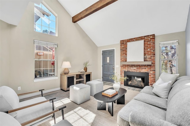 7707 S Curtice Way Unit D, Littleton, CO 80120 - living area featuring high vaulted ceiling, healthy amount of natural light, wood finished floors, beam ceiling, and a fireplace