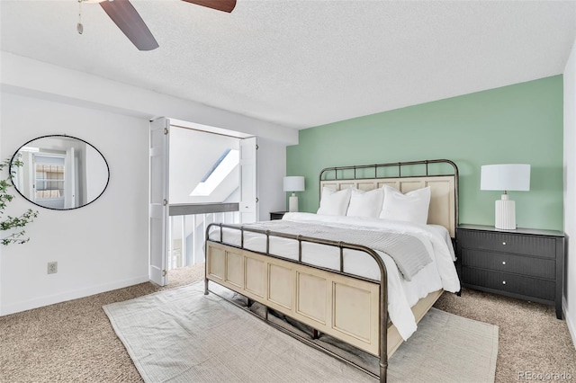 7707 S Curtice Way Unit D, Littleton, CO 80120 - bedroom with carpet, ceiling fan, baseboards, and a textured ceiling