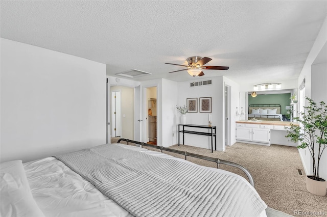 7707 S Curtice Way Unit D, Littleton, CO 80120 - bedroom with attic access, carpet flooring, a textured ceiling, and ceiling fan