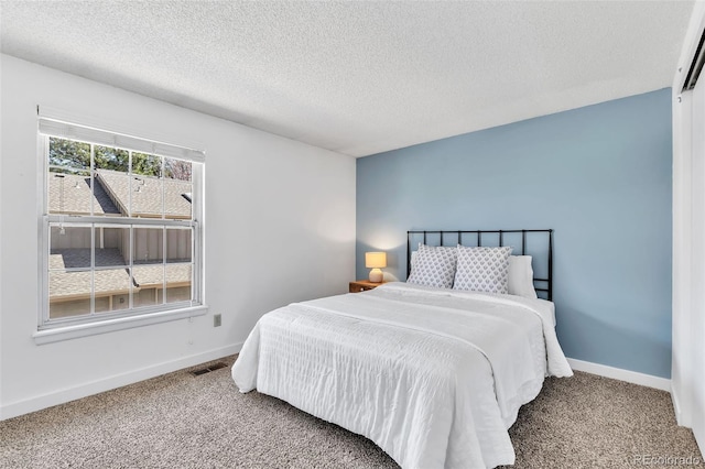 7707 S Curtice Way Unit D, Littleton, CO 80120 - carpeted bedroom with baseboards and a textured ceiling