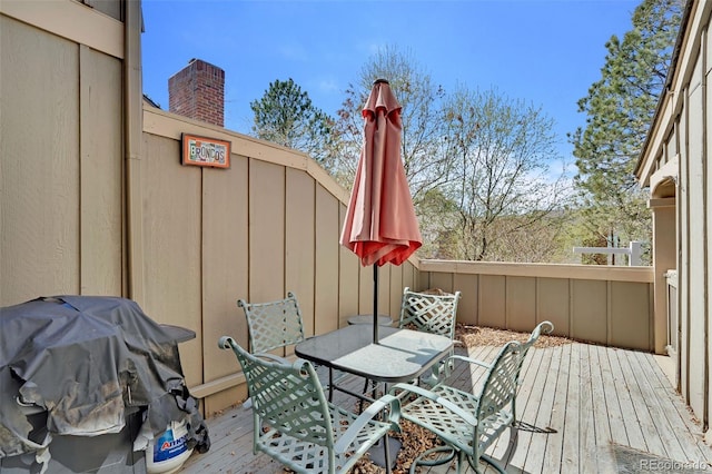 7707 S Curtice Way Unit D, Littleton, CO 80120 - wooden terrace with outdoor dining area and a grill