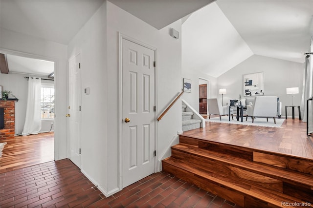 stairs featuring vaulted ceiling