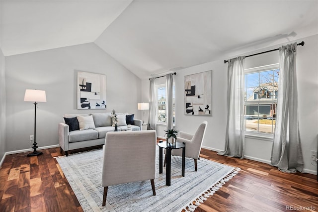 living room featuring hardwood / wood-style flooring, vaulted ceiling, and a healthy amount of sunlight