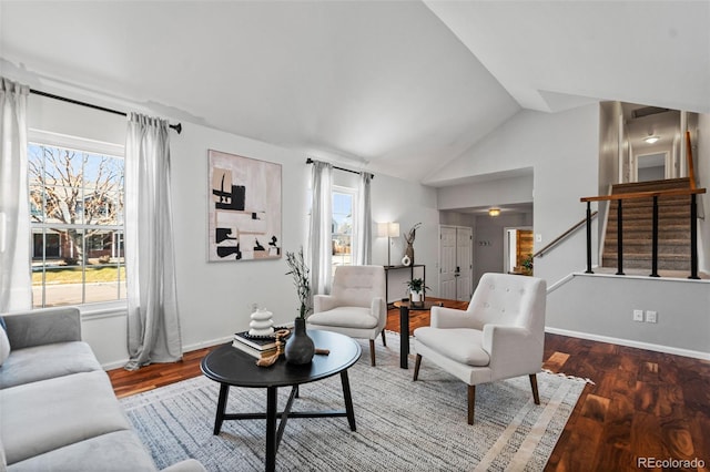 living room featuring plenty of natural light, dark hardwood / wood-style floors, and lofted ceiling